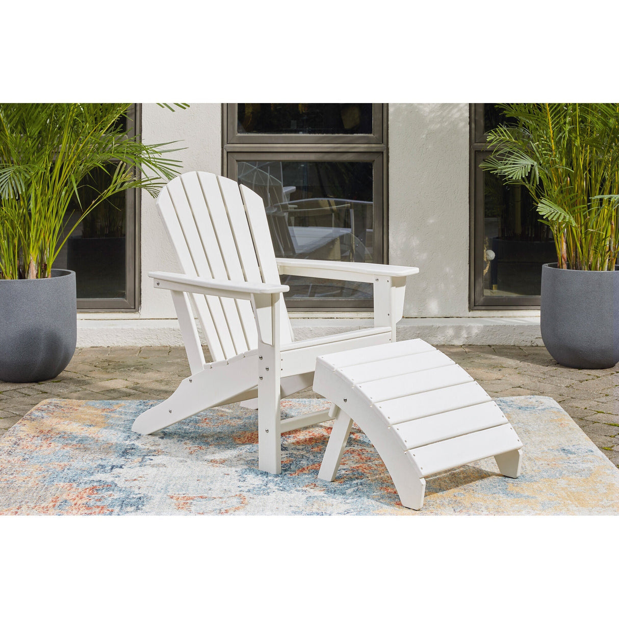 A room setting featuring Sundown White Adirondack Chair