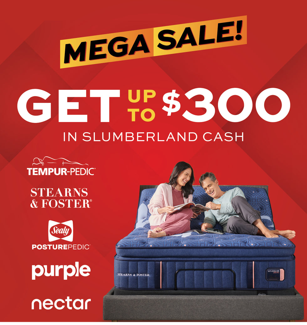 Promotional advertisement for a mattress sale featuring a blue mattress on a display stand with a couple sitting on top, set against a red background with large text reading 'MEGA SALE!' and 'GET UP TO $300 IN SLUMBERLAND CASH,' plus visible mattress brands including Tempur-Pedic, Stearns & Foster, Sealy, Purple, and Nectar.