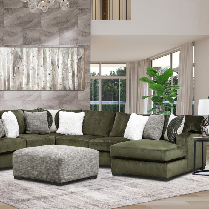 Green sectional sofa with patterned cushions in a living room setting.
