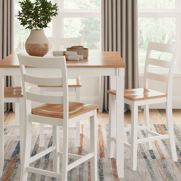 Dining room with a wooden table and chairs in front of large windows.