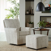 Gray textured armchair with matching ottoman in a living room setting.