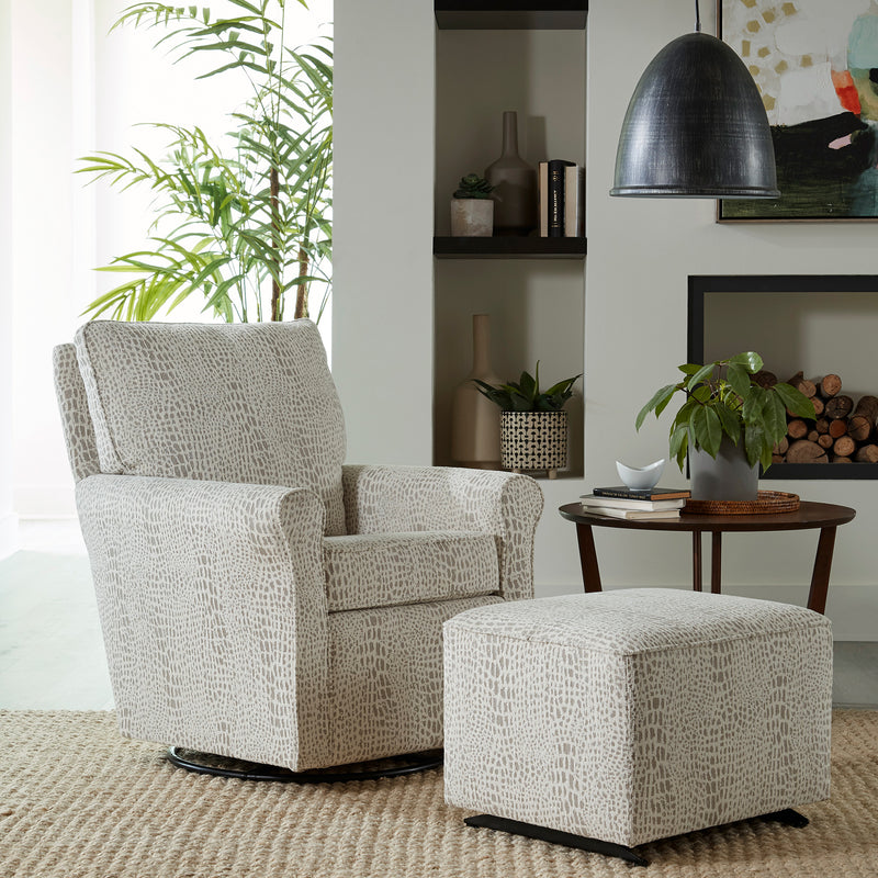 Gray textured armchair with matching ottoman in a living room setting.