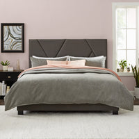 modern bed and upholstered headboard in bedroom