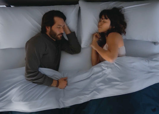 Couple sleeping facing each other