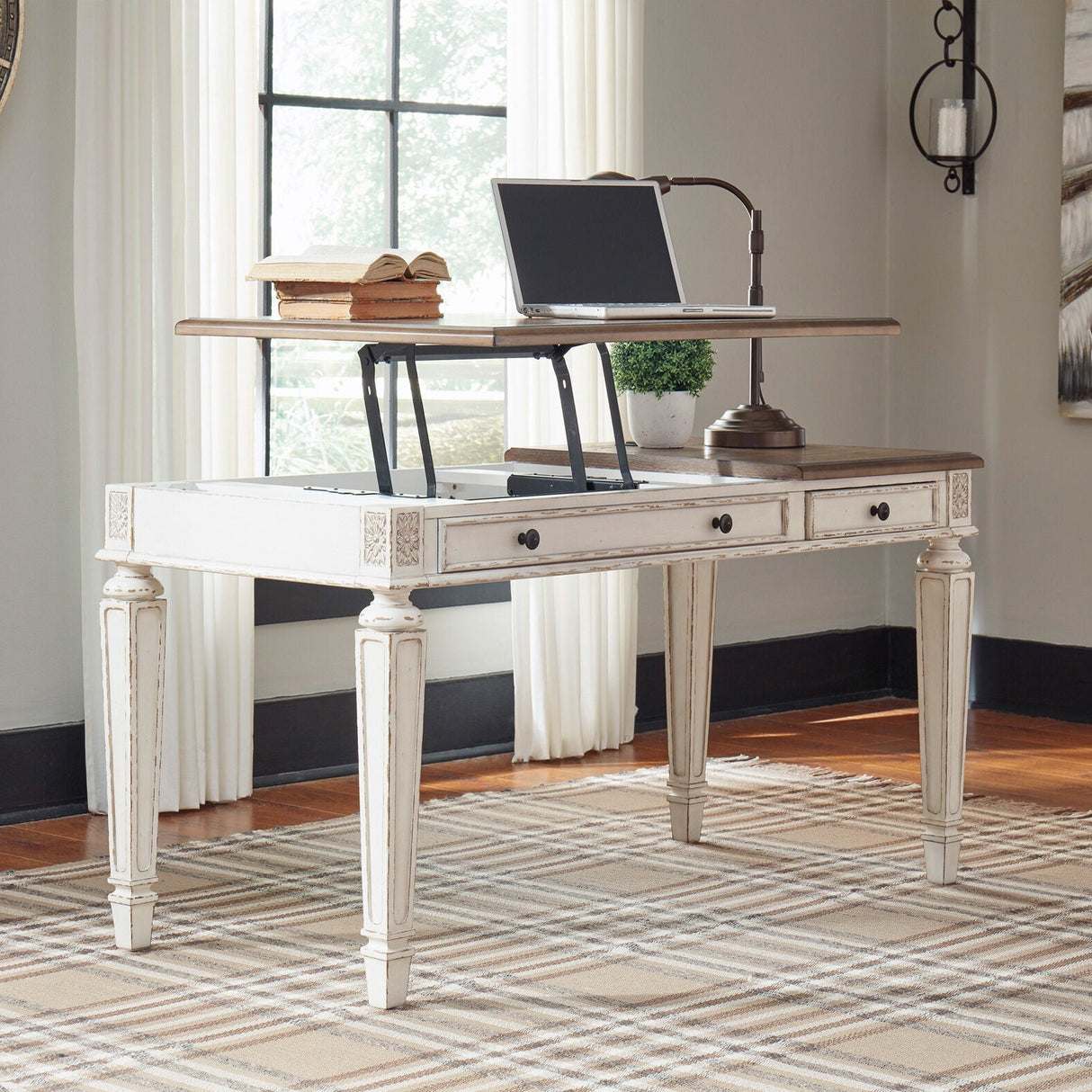 A room setting featuring Realyn White Lift Top Desk