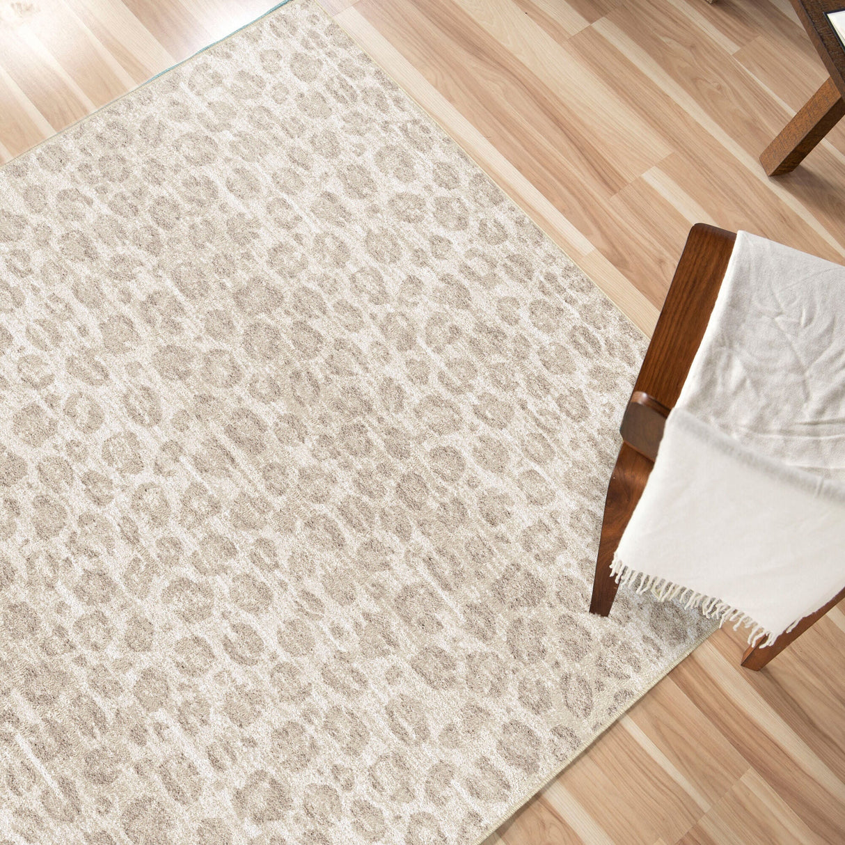 A room setting featuring Snow Leopard Beige 5x8 Rug