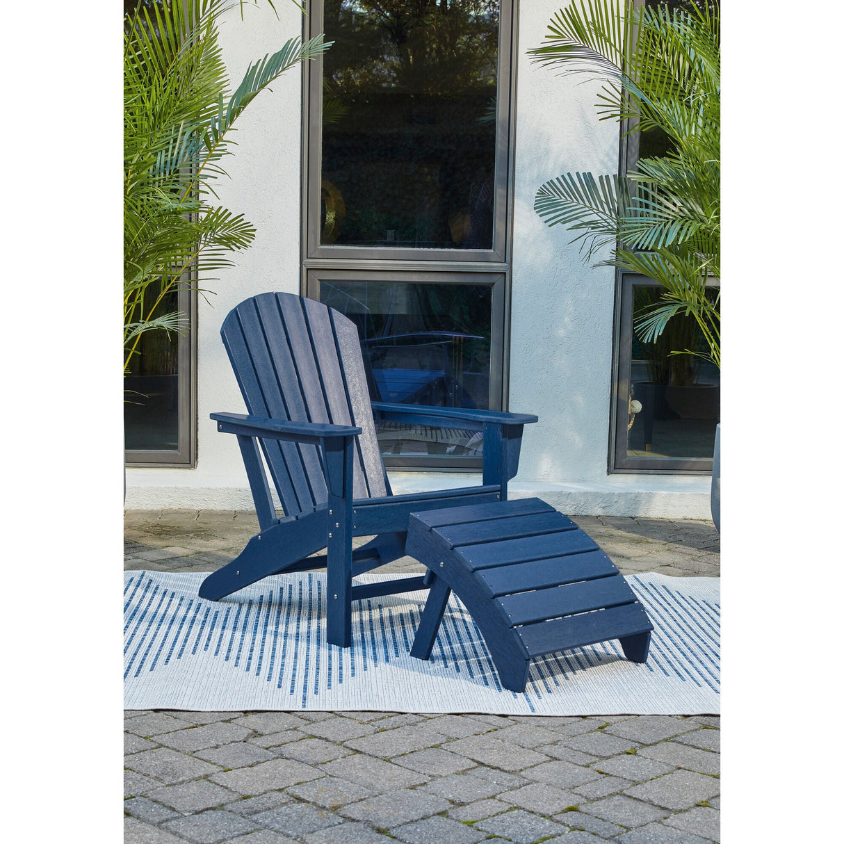 A room setting featuring Sundown Blue Adirondack Chair