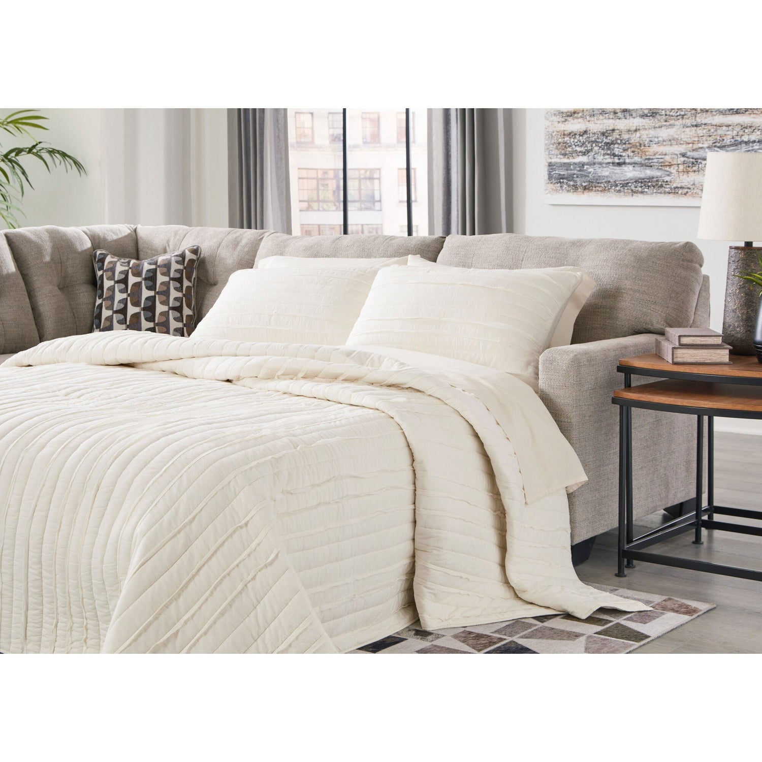 A room setting featuring Mahoney Pebble Left Chaise Full Sleeper Sectional