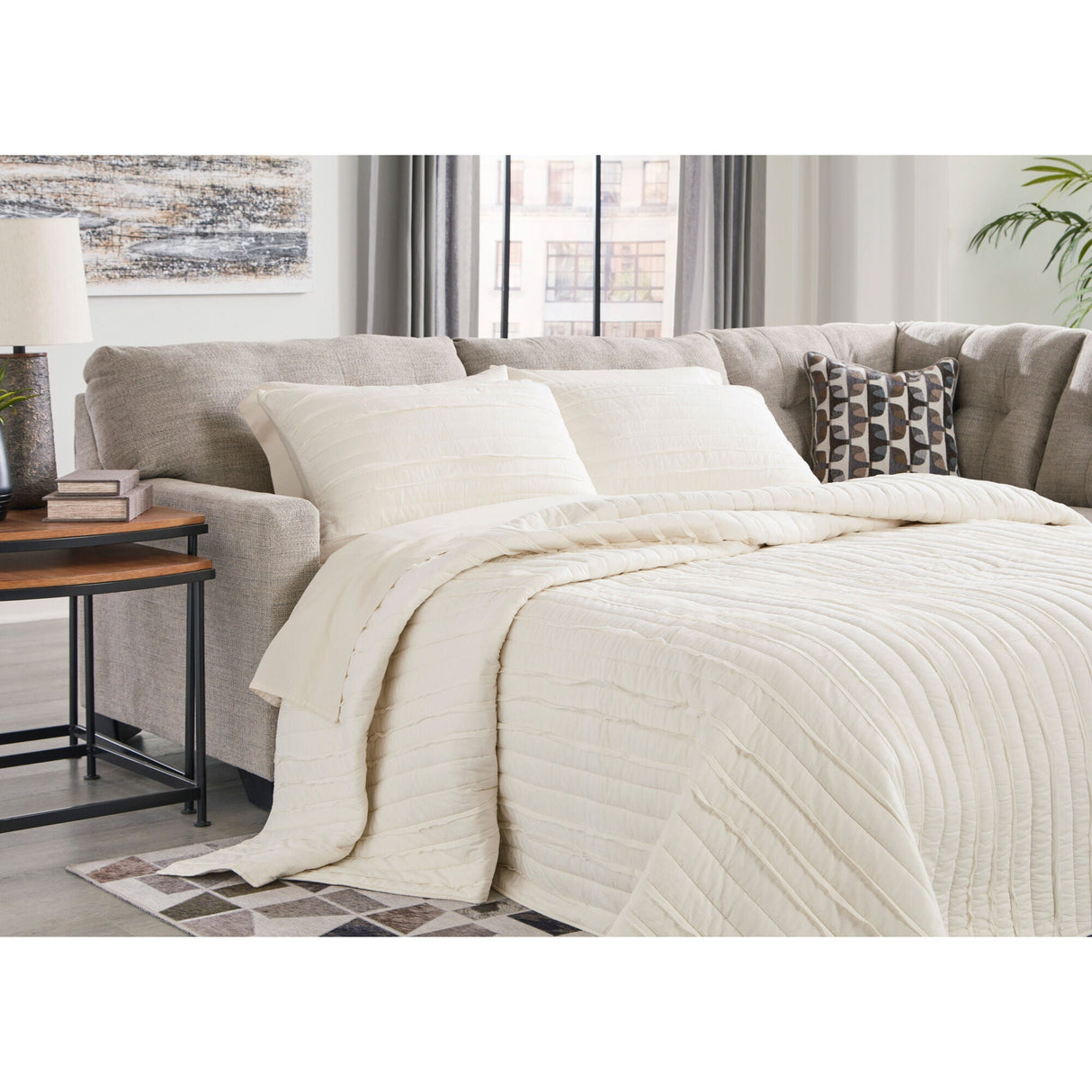 A room setting featuring Mahoney Pebble Right Chaise Full Sleeper Sectional