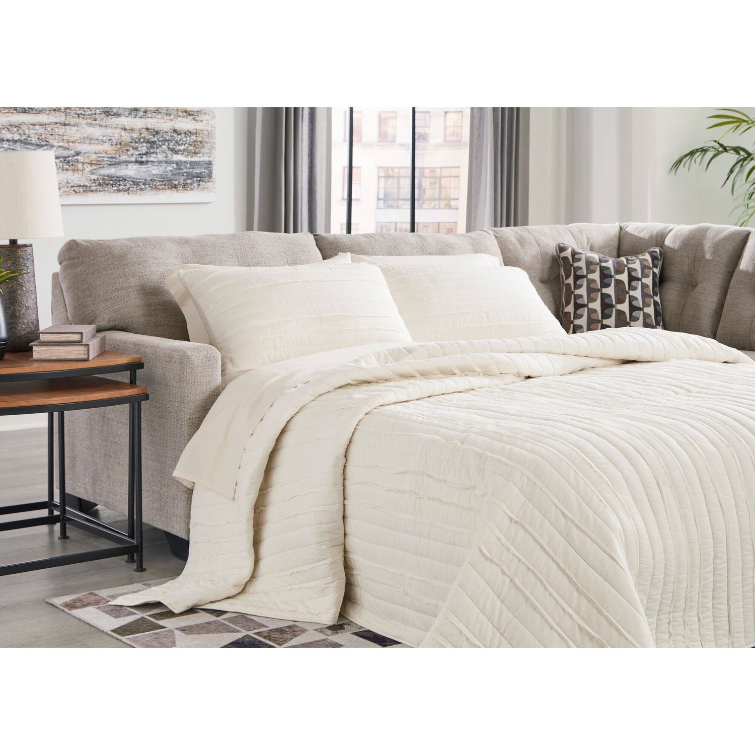 A room setting featuring Mahoney Pebble Right Chaise Full Sleeper Sectional