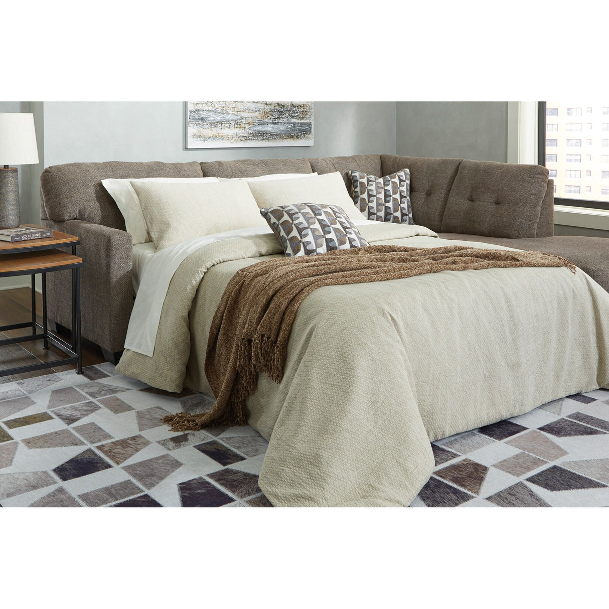 A room setting featuring Mahoney Chocolate Right Chaise Full Sleeper Sectional