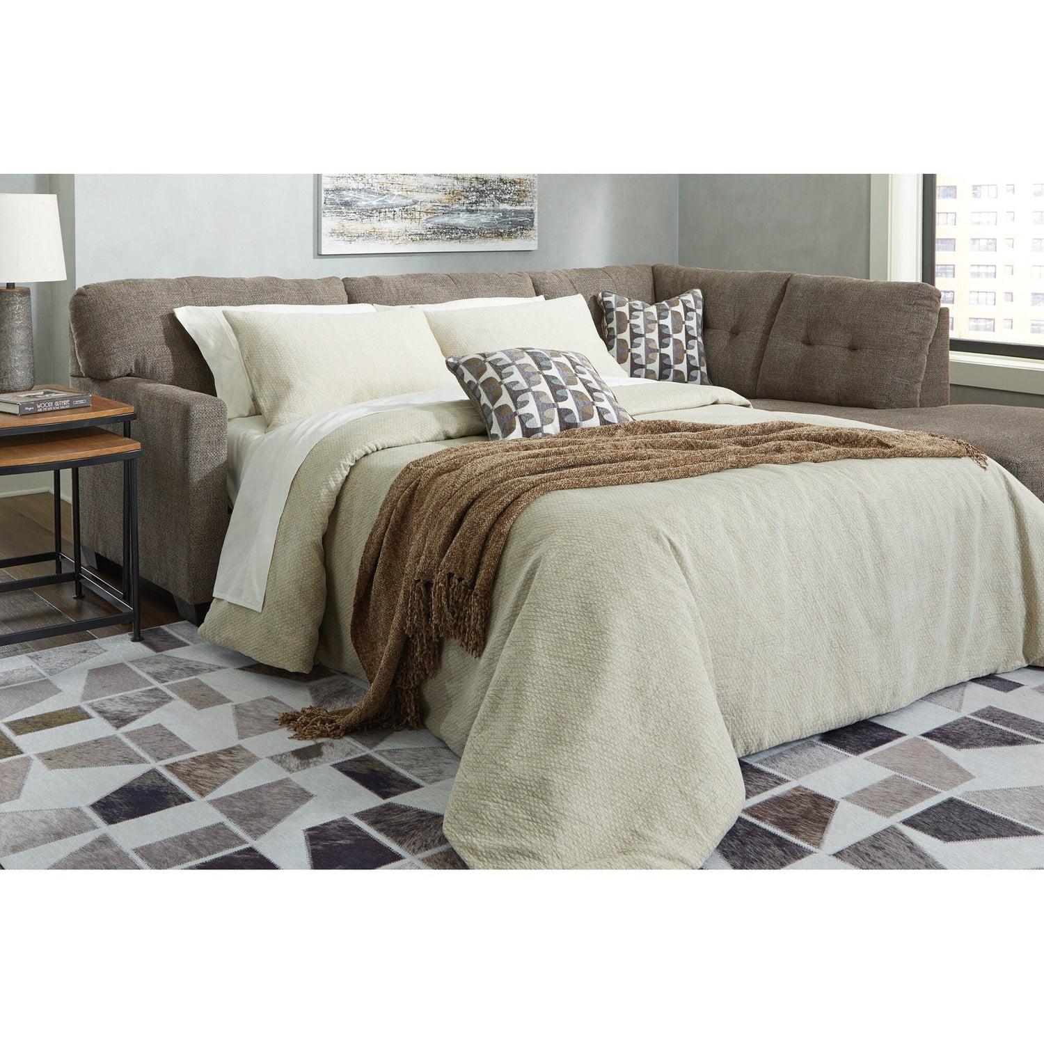 A room setting featuring Mahoney Chocolate Right Chaise Full Sleeper Sectional