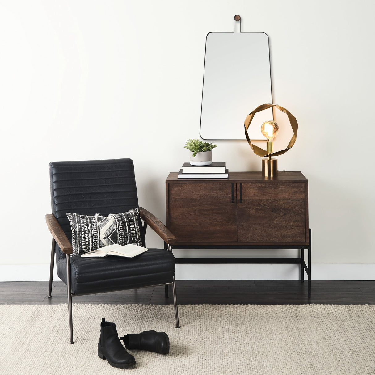 A room setting featuring Collie Black Wall Mirror
