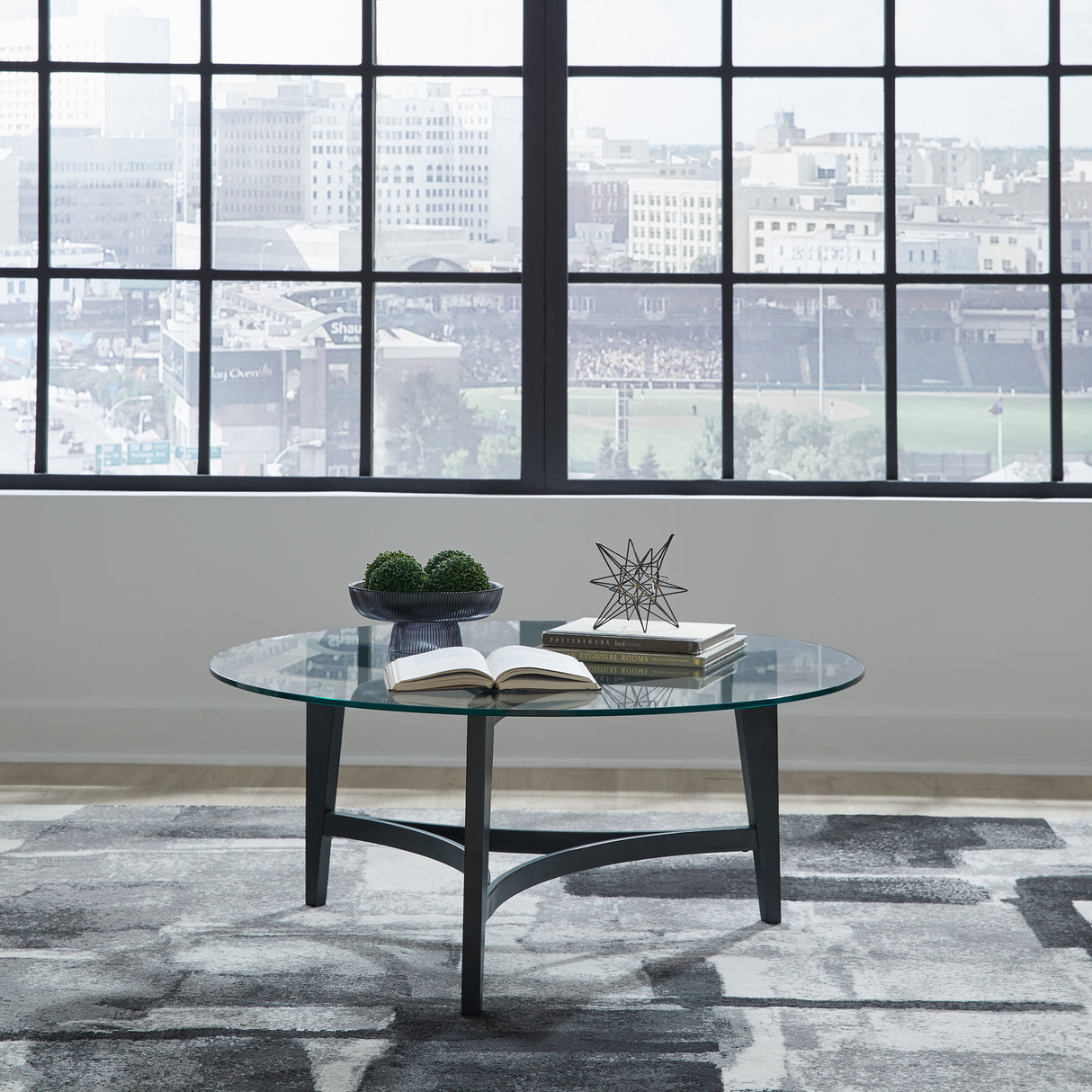 A room setting featuring Capri Glass Round Coffee Table