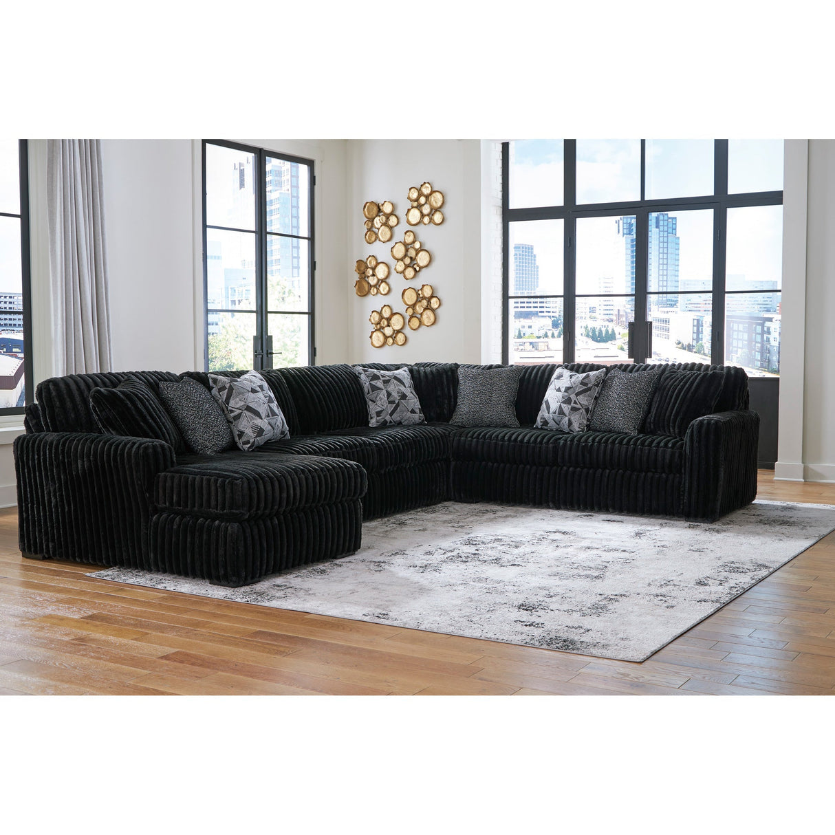 A room setting featuring Midnight Madness Onyx 4 Piece Left Chaise Sectional