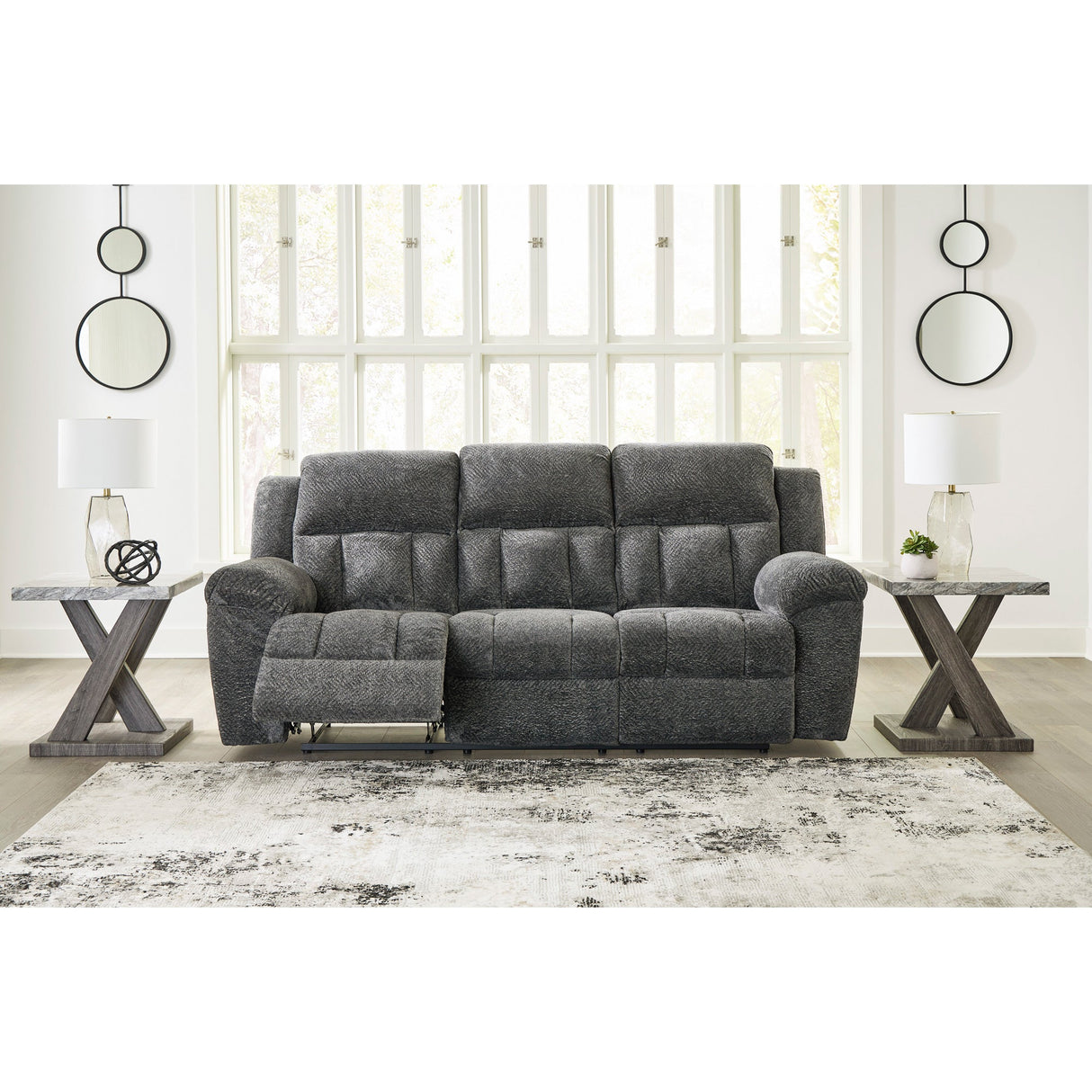 A room setting featuring Frohn Graphite Reclining Sofa
