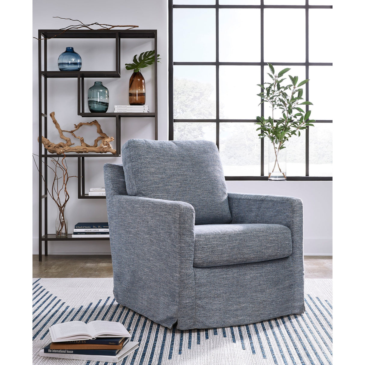 A room setting featuring Nenana Denim Next-Gen Nuvella Swivel Glider Chair