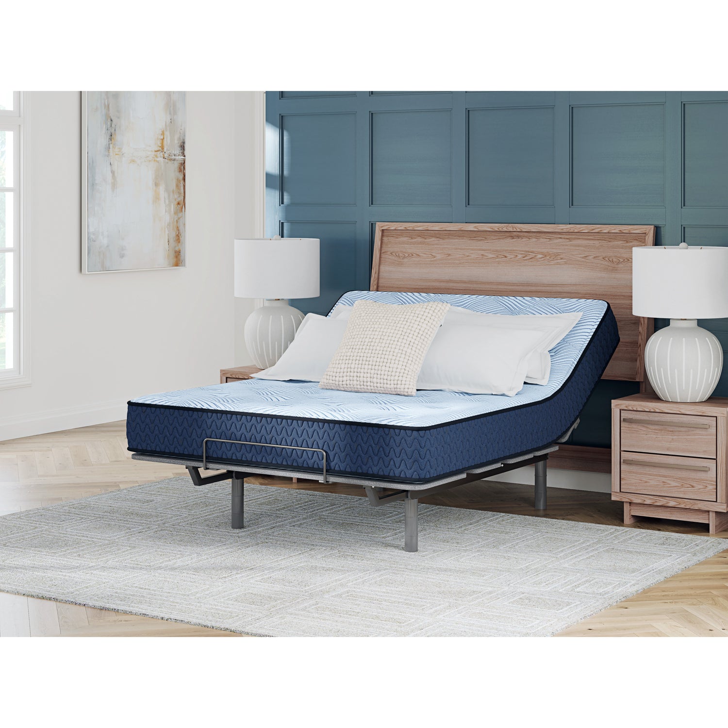 Blue adjustable bed in a room with wooden headboard and nightstands.