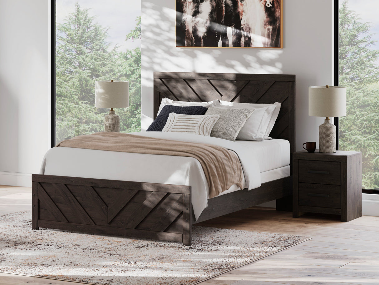 A room setting featuring Prendonea Charcoal Queen Panel Bed