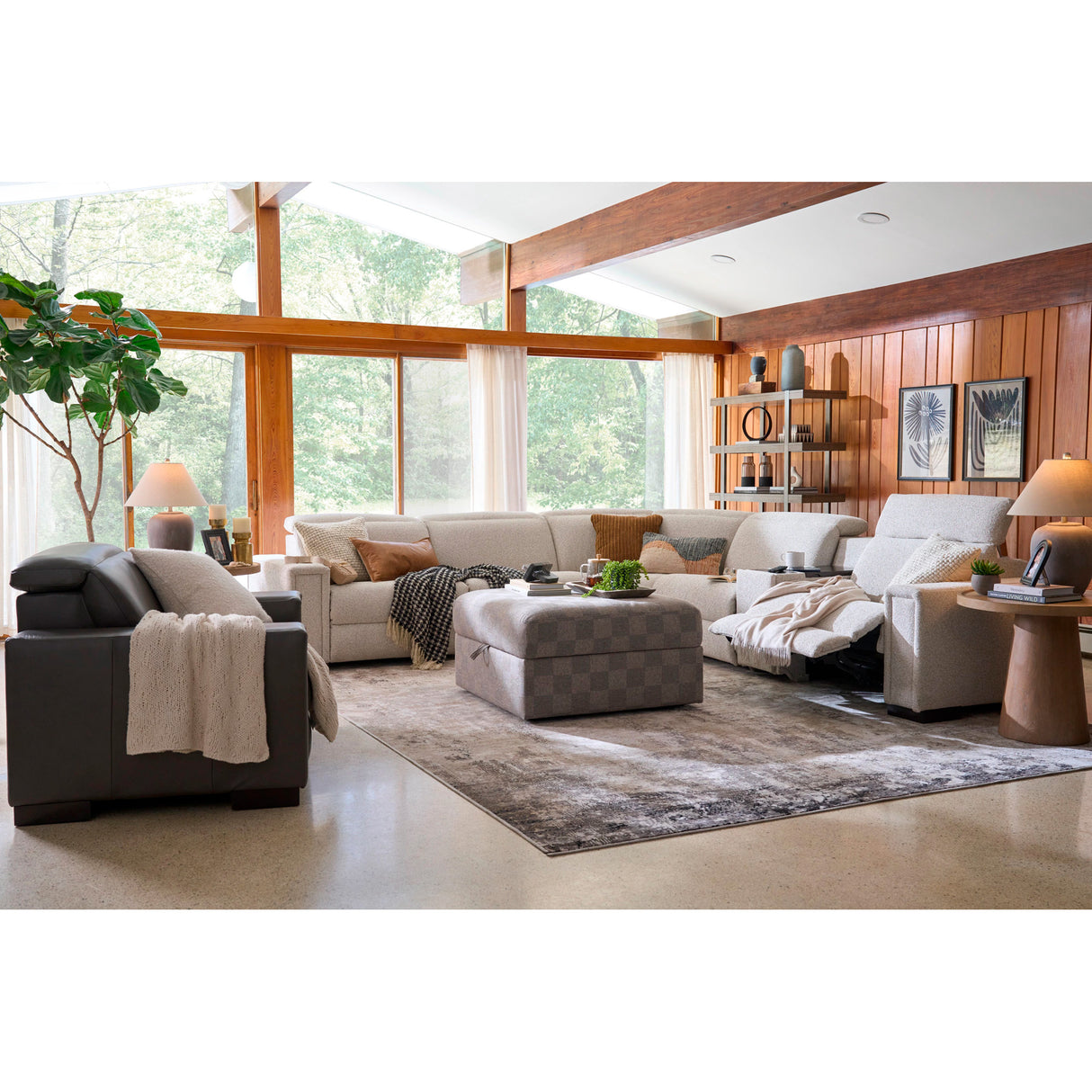 Modern living room with a gray sofa, armchair, and ottoman.