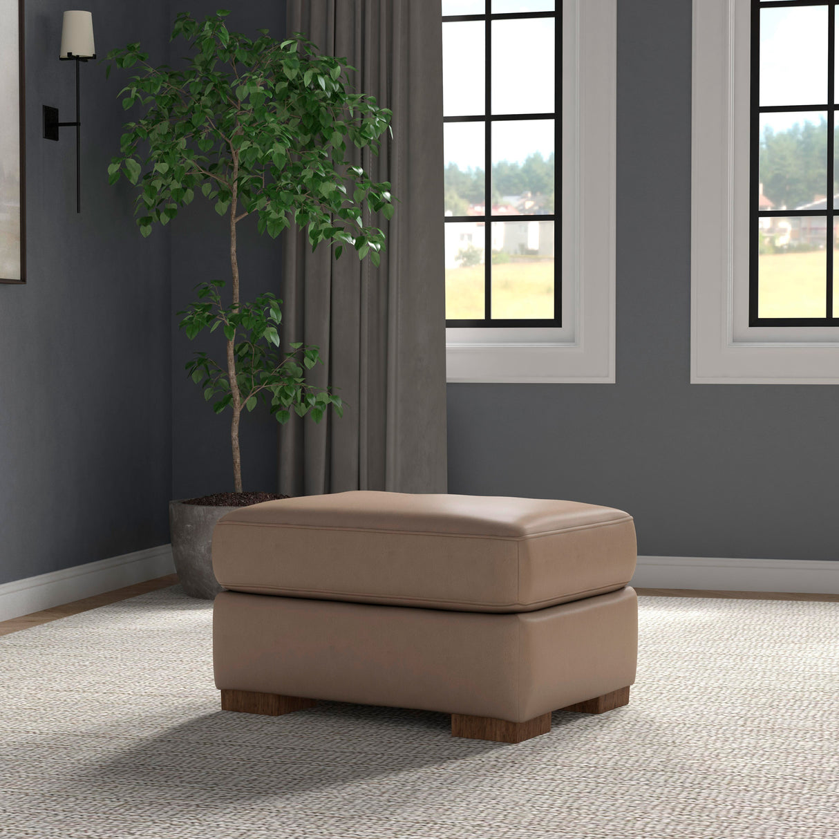 A room setting featuring Bryant Dark Stone Leather Ottoman