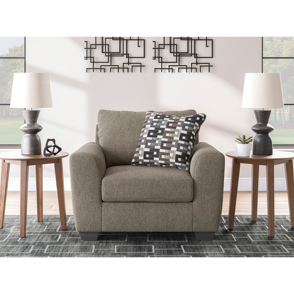 A room setting featuring Triston-Peaks Suede Chair and a Half
