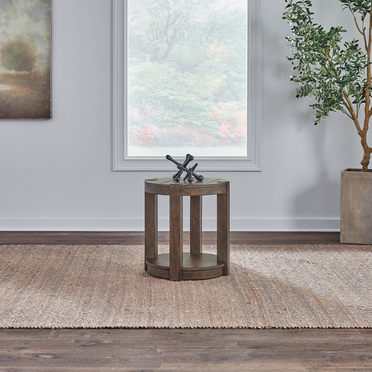 A room setting featuring Broadmore Cobblestone Brown Round Chairside Table