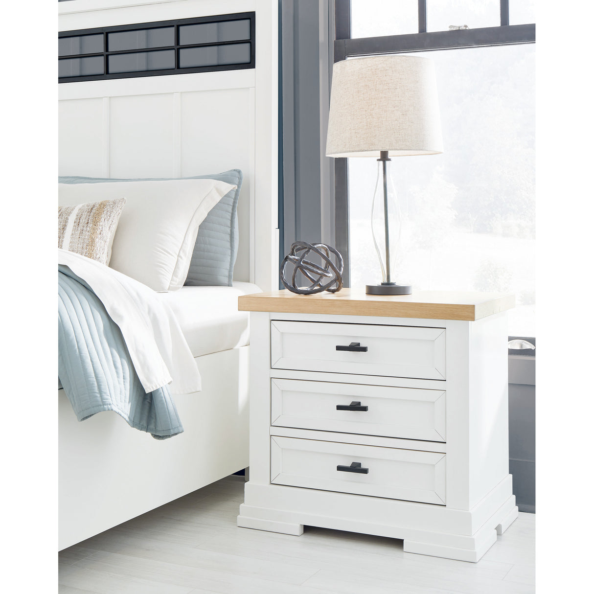 A room setting featuring Ashbryn White 3 Drawer Nightstand