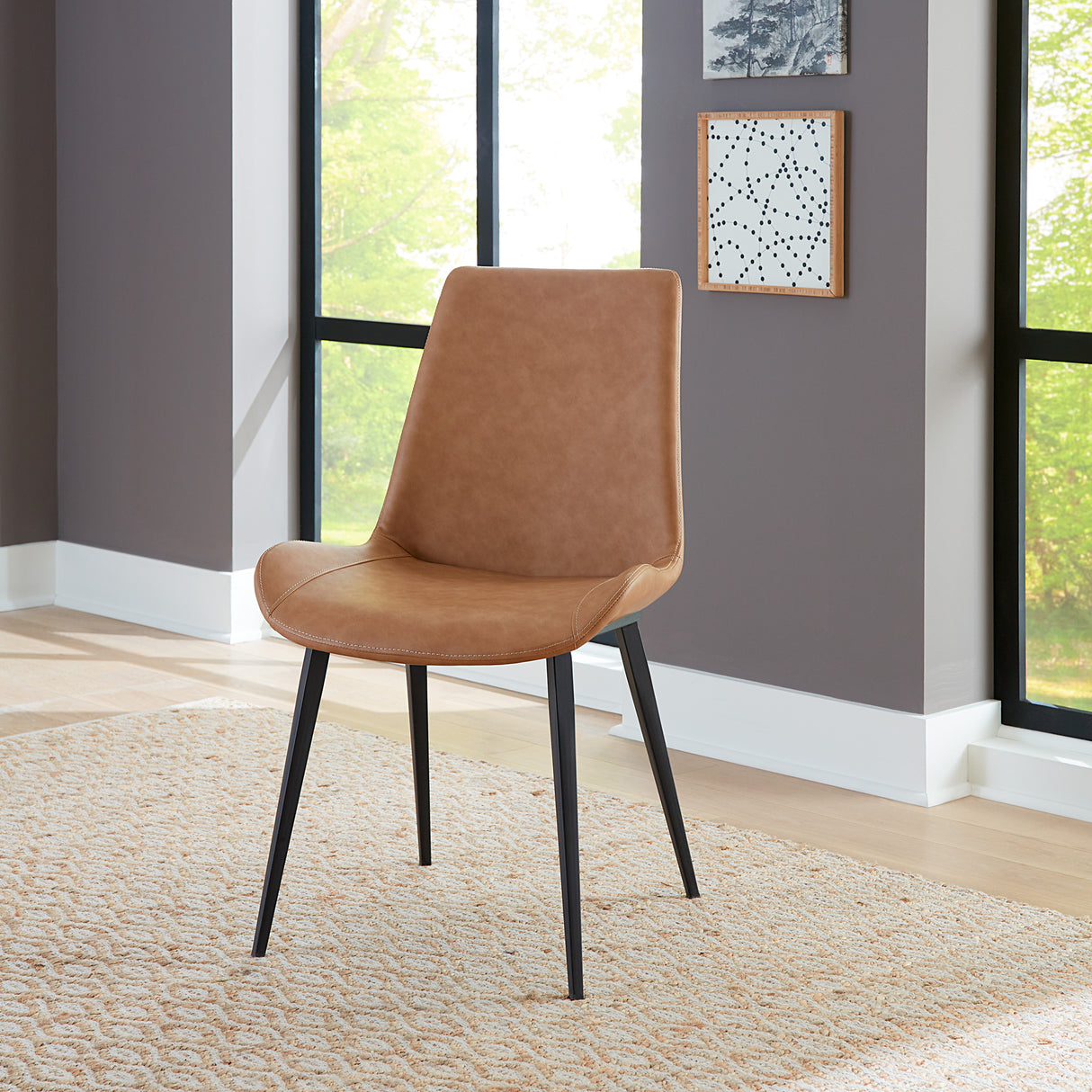 A room setting featuring Nicoya Buckskin Dining Chair