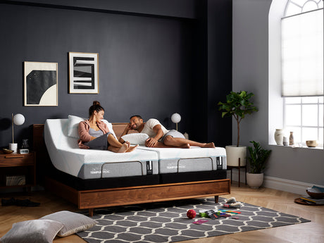 Couple laying on a split king mattress