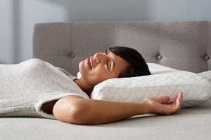 woman laying on pillow smiling