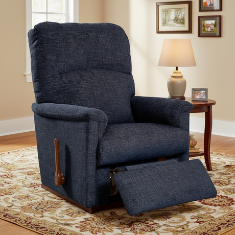 Blue recliner chair in a living room setting with a lamp and framed pictures on the wall.