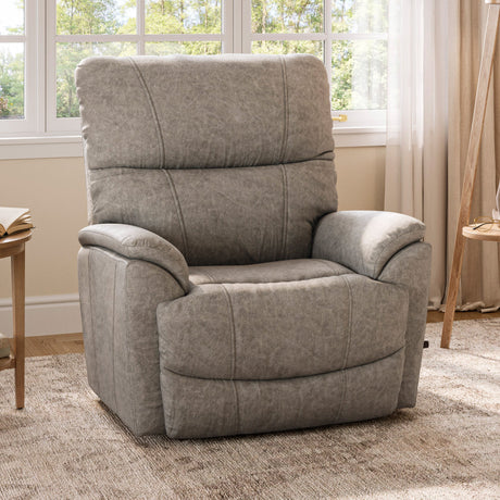 Gray recliner chair in a living room setting with windows and curtains.