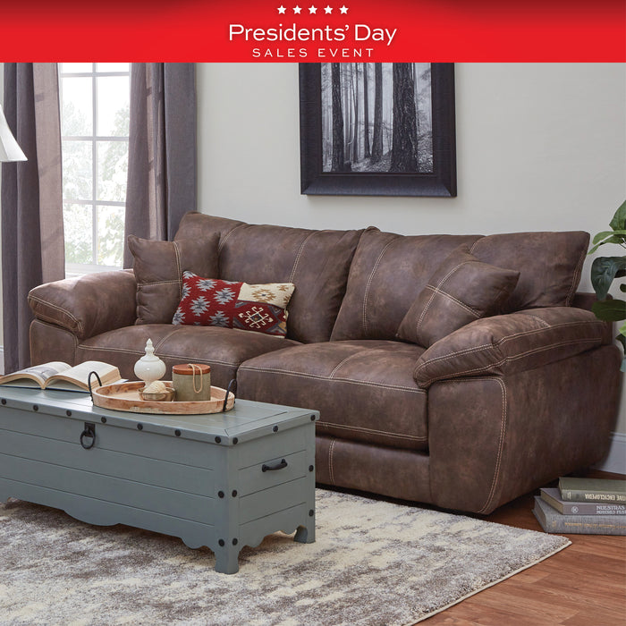 Brown leather sofa with decorative pillows in a living room setting, featuring a 'Presidents' Day Sales Event' banner.