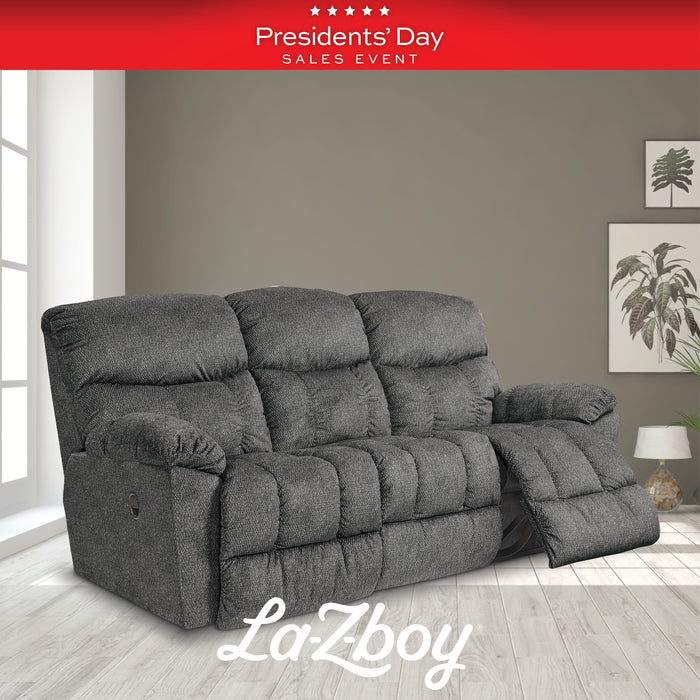 Gray La-Z-Boy sofa in a room with a 'Presidents' Day Sales Event' banner.