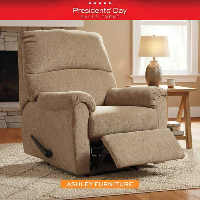 Beige recliner chair in a living room setting with 'Presidents' Day Sales Event' banner and Ashley Furniture logo.