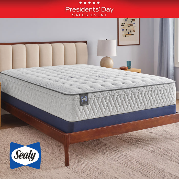 Sealy mattress on a bed frame with 'Presidents' Day Sales Event' banner in the background