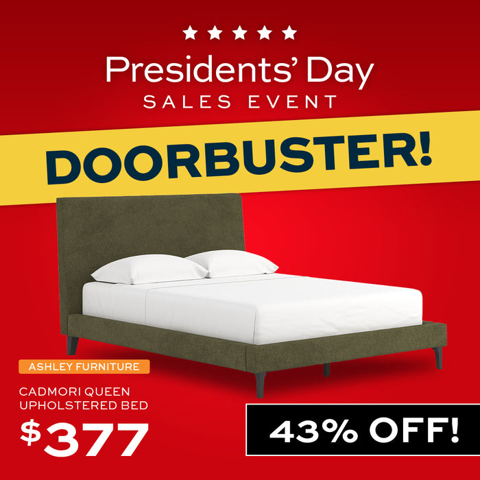 Green bed in a room with 'DOORBUSTER!' text at the top.