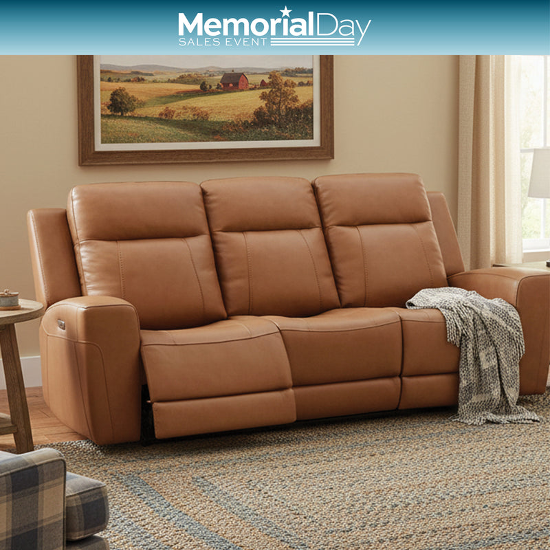 Brown leather sofa with reclining feature in a room with decorative plants, featuring Memorial Day sales text.