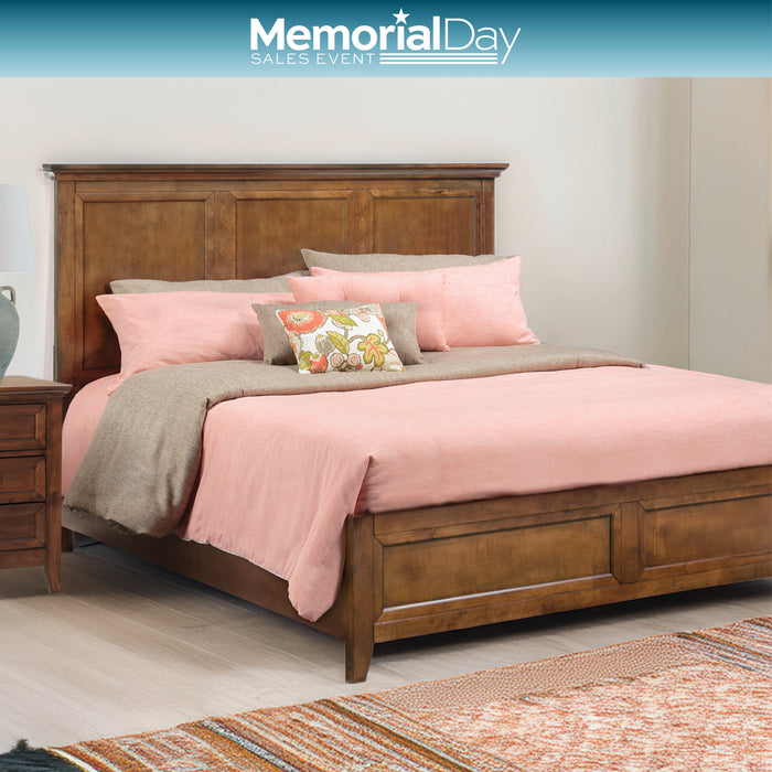 Bedroom with wooden bed and pink bedding, featuring Memorial Day sales event text.
