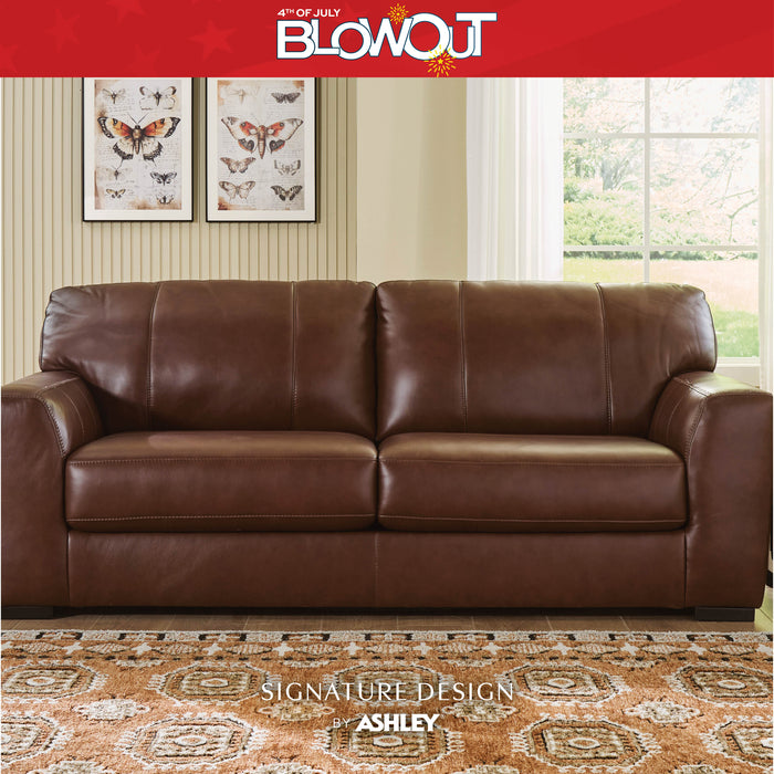 Brown leather sofa in a living room setting with '4th of July Blowout' and 'Signature Design by Ashley' text.