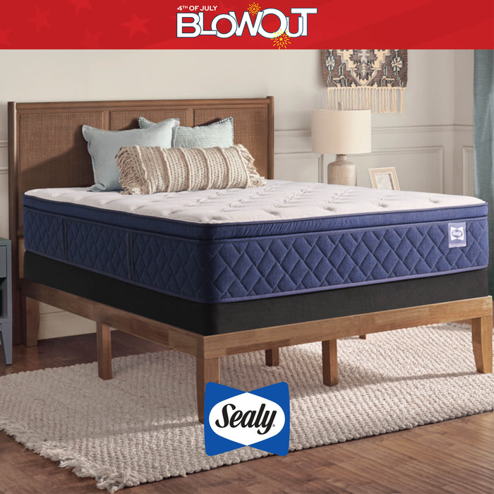 Sealy mattress on a wooden bed frame with '4th of July Blowout' text and Sealy logo.