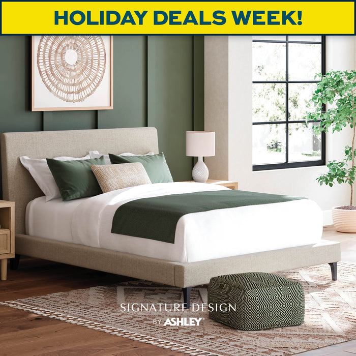 Modern bedroom with bed and decor, featuring a 'Holiday Deals Week!' banner and Ashley Furniture logo.