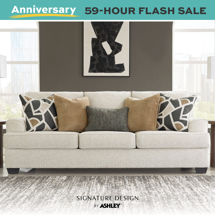 Gray sofa with patterned pillows in a living room setting, part of an Anniversary 59-Hour Flash Sale by Signature Design by Ashley.