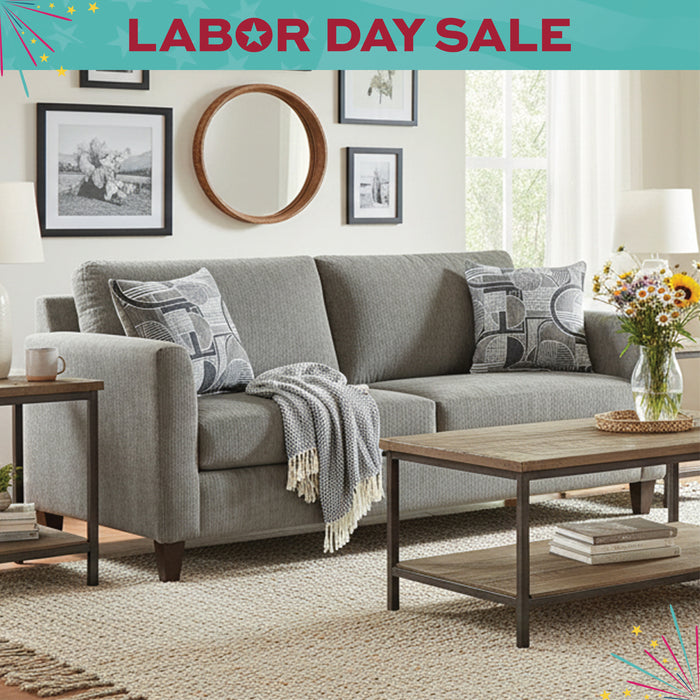 Gray sofa with decorative pillows in a living room setting, Labor Day sale banner at the top.