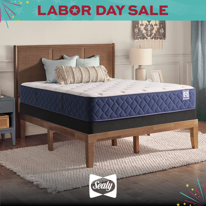 Sealy mattress on a wooden bed frame with 'Labor Day Sale' text and Sealy logo.