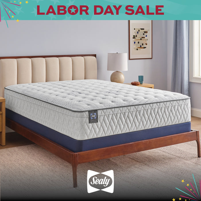 Sealy mattress on a bed frame with 'Labor Day Sale' text and Sealy logo.