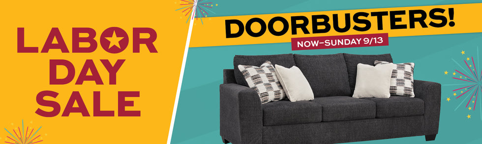 Labor Day Sale promotional banner featuring a dark gray fabric sofa with white and patterned throw pillows on a teal background, alongside large text reading 'LABOR DAY SALE' and 'DOORBUSTERS! NOW-SUNDAY 9/13'.