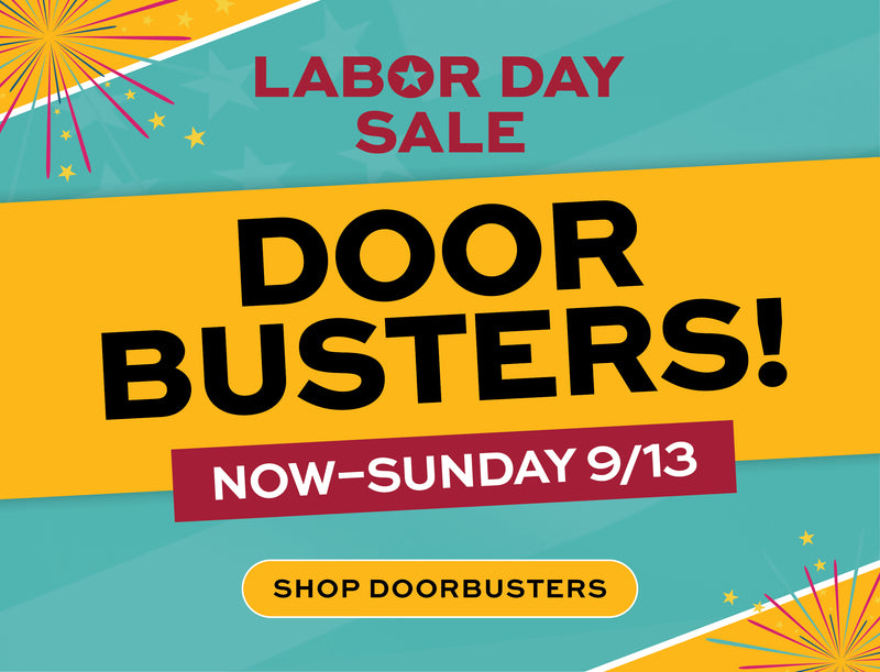 Labor Day Sale promotional graphic with large text reading 'DOOR BUSTERS!' on a yellow band, 'NOW-SUNDAY 9/13' on a maroon banner, and 'SHOP DOORBUSTERS' on a yellow button. Decorative fireworks and teal/orange background shapes surround the text.
