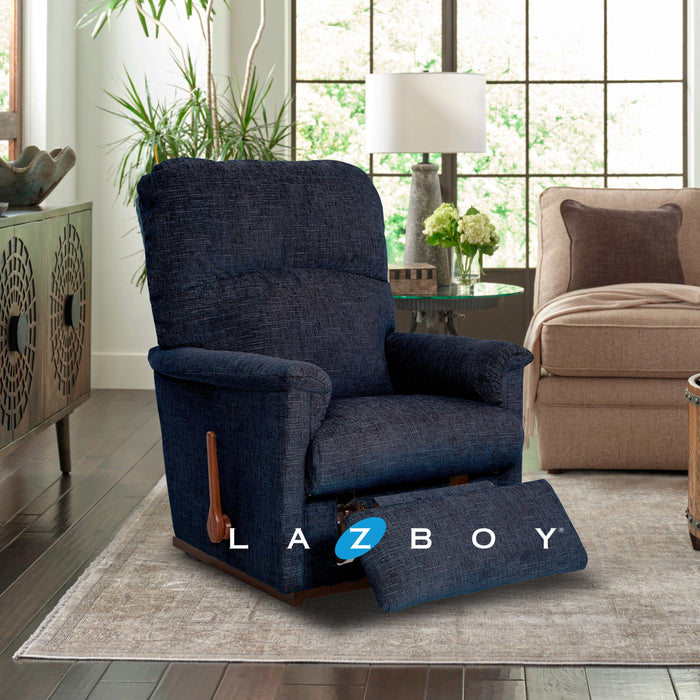 Blue recliner chair in a living room with a beige sofa and large window.